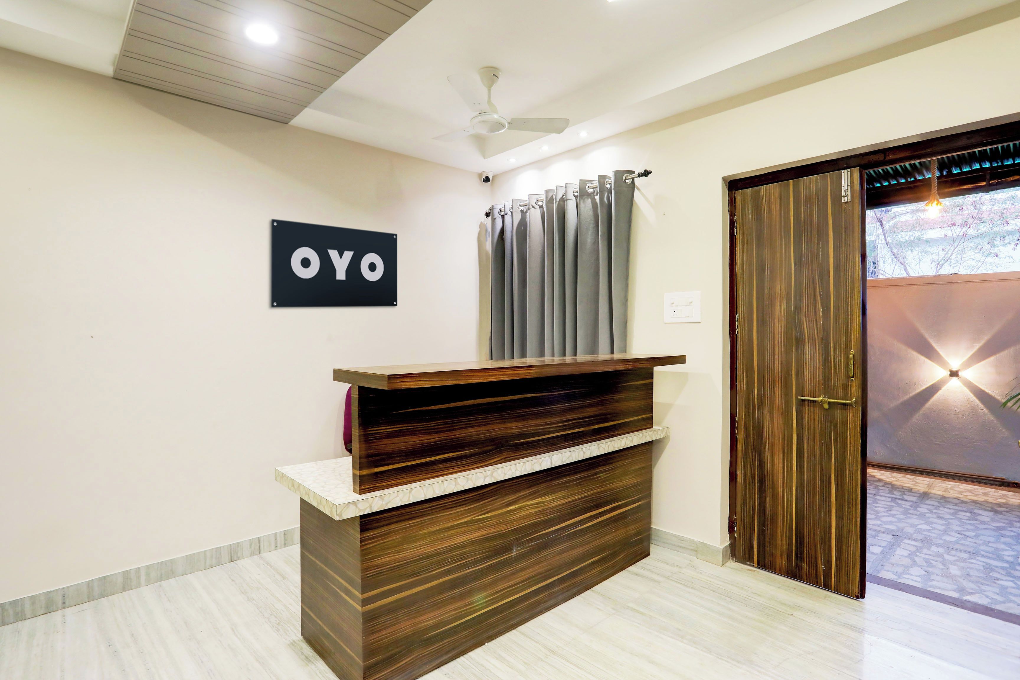 A reception desk with a sign that reads 'OYO' in a hotel lobby.