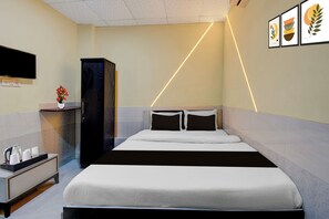 A hotel room with a bed, bedside table, a cabinet, a TV mounted on the wall, and a wall with framed artwork. - Hotel O Talegaon MIDC Goodluck Lodge (Pune)