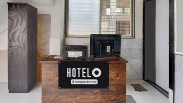 A reception desk with a sign reading 'HOTEL' and 'Company-Serviced'.