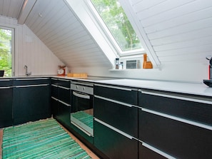A kitchen with a skylight, a sink, and a window overlooking greenery. - 8 Person Holiday Home in Hemmet (Hemmet)
