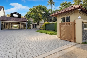 A residential property with a paved driveway, a gated entrance, and a covered parking area. - Palette Sealine Beach Resort,  (Kochi)