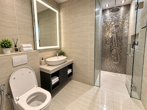 A modern bathroom with a toilet, sink, and shower. - Star Residences KLCC -Royale Stay  (Kuala Lumpur)
