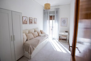 Une chambre à coucher avec un lit, un bureau et une armoire.