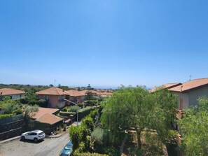 A residential area with houses, a street, and a clear sky. - Il Giardino dell'Etna (Mascalucia)