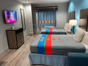 A hotel room with two beds, a TV, a desk, and a wardrobe. - Convenient Downtown Stay + Free Breakfast&Parking (Houston)