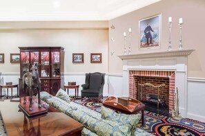 A room with a fireplace, a sofa, a cabinet, and a horse statue. - Near Gettysburg National Military Park +Restaurant (Gettysburg)