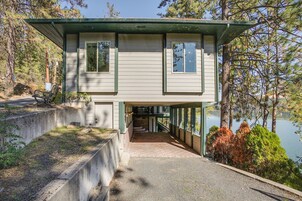 A two-story building with a covered porch and a staircase leading to the upper level.
