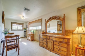 A room with a wooden dresser, a chair, a table, and a mirror. - Romantic Mtn-view Suite w/ Jacuzzi Tub in Pine (Pine)
