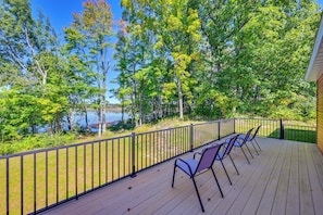 A wooden deck with metal railings, overlooking a lake and surrounded by trees. - Large Deck w/ Views! Brand New Three Rivers Home (Three Rivers)