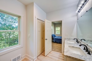 A modern bathroom with a large mirror, two sinks, and a shower. - Large Deck w/ Views! Brand New Three Rivers Home (Three Rivers)