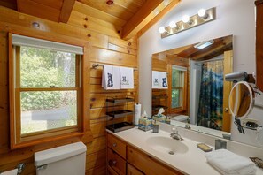 A wooden cabin bathroom with a toilet, sink, and mirror. - Mtn Views From Every Deck Without The Mtn Drive! (Maggie Valley)