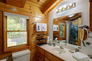 A wooden cabin bathroom with a toilet, sink, and mirror. - Mtn Views From Every Deck Without The Mtn Drive! (Maggie Valley)