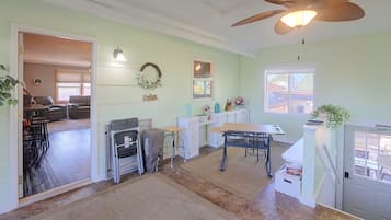 A spacious kitchen with a dining area, a ceiling fan, and a view of the outside.