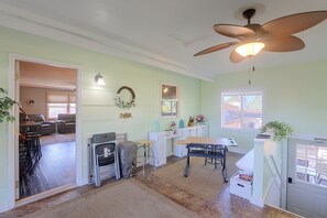 A spacious kitchen with a dining area, a ceiling fan, and a view of the outside.