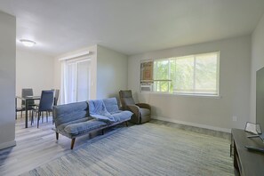 A living room with a sofa, chairs, a dining table, and a large window with blinds. - Central Lacey Home: 3 Mi to Dtwn Olympia (Lacey)