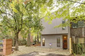 A modern building with a brick column, a gravel driveway, and a wooden fence. - Walk to the Stadium & Clemson: 3BR w/ Parking! (Clemson)