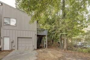 A two-story building with a garage and a small outdoor staircase leading to a second level. - Walk to the Stadium & Clemson: 3BR w/ Parking! (Clemson)