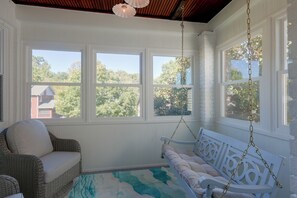 A room with a wicker chair, a swing, and a view of trees through large windows. - 4 Mi to Dtwn & Bengals Games! Multi-level Charmer (Covington)