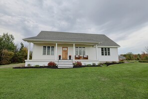 A single-story house with a front porch, a door, and a small set of steps leading up to it. - 50-acre Hilltop Home: Upstate Getaway (Mooers)