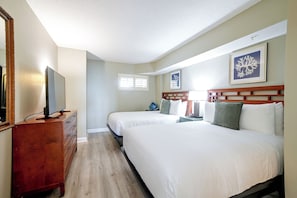 A hotel room with two beds, a dresser, a television, and a framed artwork on the wall. - Ocean-view Dunes Village Condo: Water Park & Pools (Myrtle Beach)