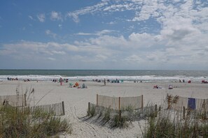 A beach with a wooden fence, sandy shore, and the ocean. - Ocean-view Dunes Village Condo: Water Park & Pools (Myrtle Beach)