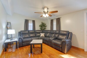 A living room with a sectional sofa, a small table, a lamp, and a ceiling fan. - Beach Escape 1 Mi to Okaloosa Island & Dtwn (Fort Walton Beach)