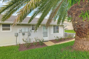 A residential house with a front yard, a palm tree, and a small garden area. - License to Chill: Lake Access, 14 Mi to Disney (Clermont)