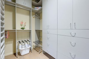 A modern closet with multiple drawers and shelves, a hanging rack, and a laundry basket. - Desert Hills Fenced Acre! Pool, Spa + Dogs Allowed (Phoenix)