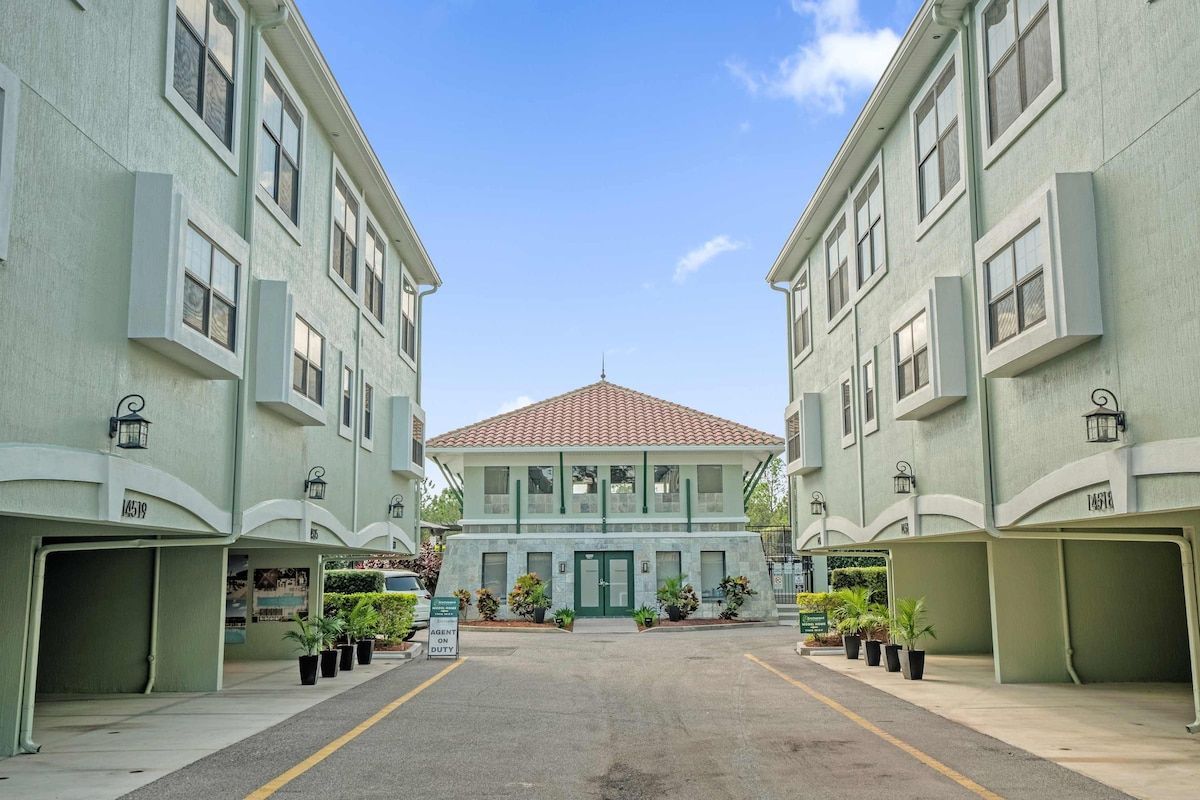 A building with a central entrance, multiple windows, and a tiled roof.