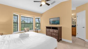 A bedroom with a bed, a dresser, a ceiling fan, and a window with blinds.