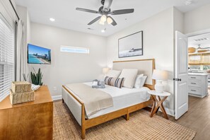 A bedroom with a bed, bedside tables, a ceiling fan, and a view of the beach. - Casa Bella | Family Coastal Retreat | Ocean Views (Myrtle Beach)