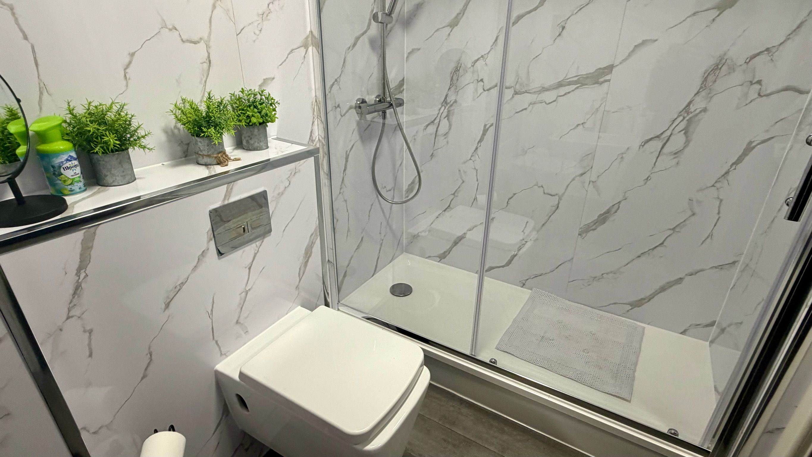 Un baño con ducha, inodoro y lavamanos.