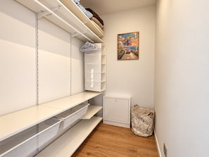 A room with white shelves, a small white cabinet, and a painting on the wall. - Modern Villa Istria in Nedescina (Nedescina)