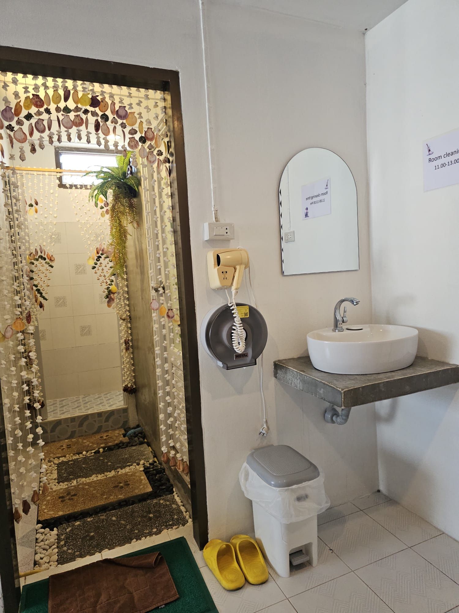 A bathroom with a sink, mirror, and a telephone.
