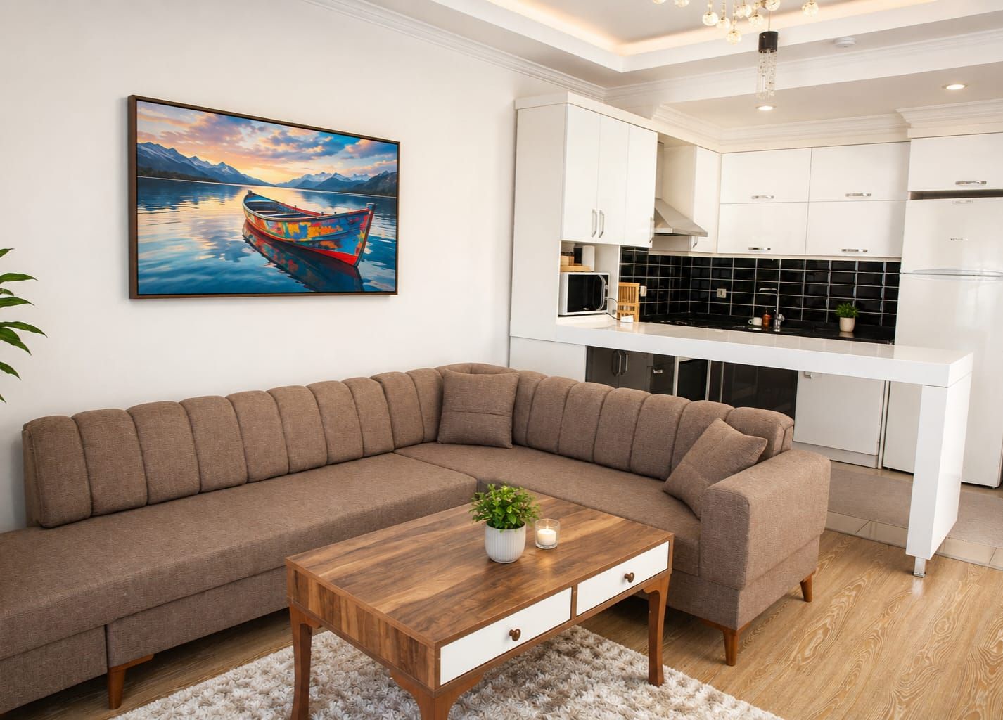 A modern living room with a sofa, a coffee table, and a kitchen area with white cabinets and black backsplash.
