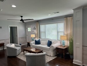 A living room with a sofa, armchairs, a coffee table, and a ceiling fan. - 3 Bedroom, 2 Full Bath Luxurious Park Circle Retreat (North Charleston)