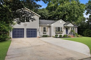 A two-story house with a garage, a front porch, and a well-maintained lawn. - 3 Bedroom, 2 Full Bath Luxurious Park Circle Retreat (North Charleston)
