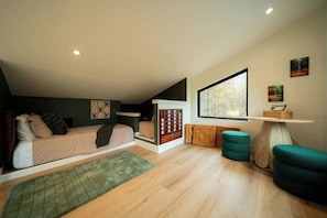 A modern bedroom with a bunk bed, a large window, and a small table with a basket. - Hilltop Luxury Cabin Views, Sauna & Hot Tub (South Bloomingville)