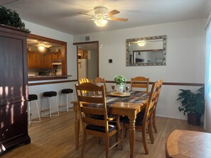 A dining area with a wooden table, chairs, and a ceiling fan. - A beautiful spacious 4-BDR house in great location! (Albuquerque)