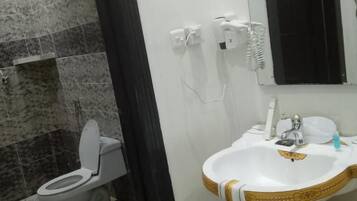 Un baño con inodoro, lavabo y espejo.