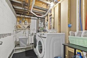 A laundry room with a washing machine, a drying rack, and a sink. - 1/4 mile to Track 3/4 to Downtown Hot Tub | 5BR (Saratoga Springs)