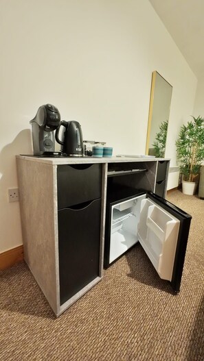 A compact kitchenette with a coffee maker, a small refrigerator, and a microwave. - The Galway Getaway-Spacious family room/Perfect to Explore the Wonders of Galway (Galway)