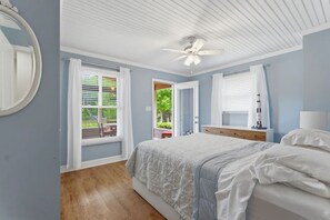 A bedroom with a bed, a ceiling fan, and a window with curtains. - Lake Front Retreat with Private 2-Story Dock (Estill Springs)