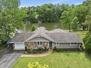 A two-story house with a stone facade, a garage, and a driveway. - Lake Front Retreat with Private 2-Story Dock (Estill Springs)