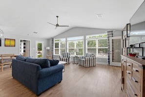 A spacious living area with a sofa, armchairs, and a dining table. - Lake Front Retreat with Private 2-Story Dock (Estill Springs)