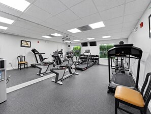 A gym with treadmills, elliptical machines, and a weight bench. - Suites at Lake Buena Vista close Disney Spring (Orlando)