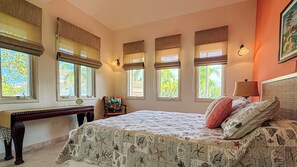 A bedroom with a bed, a desk, and multiple windows. - ccLarge Luxurt\  Home for Groups & Families, Direct on Beach w.Golf Cart (Dorado)