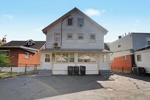 A two-story house with a front porch, a garage, and a fenced yard. - Cincy 5BR Escape Zoo Xavier Sleeps 7 (Cincinnati)