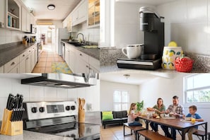 A modern kitchen with a built-in oven and microwave, a dining area with a table and chairs, and a living room with a sofa and a coffee table. - 3-BR Beach House in enchanting St. Petersburg Pool, Grill & More (St. Petersburg)