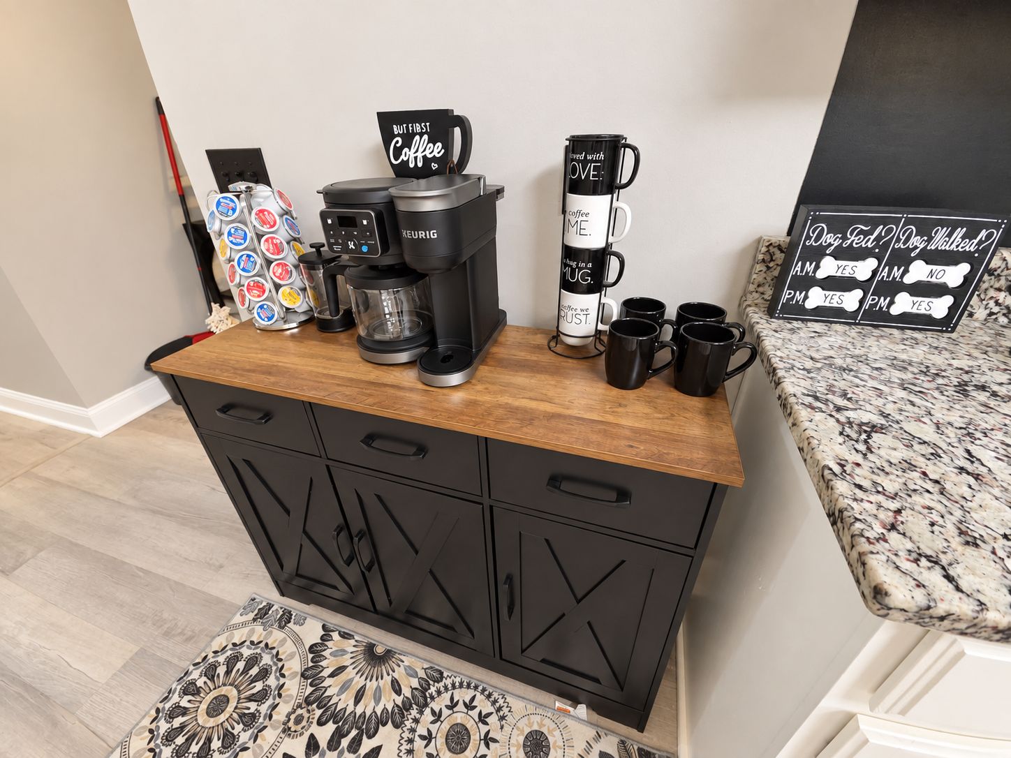 A kitchenette with a coffee maker, mugs, and a sign indicating dog walking services.